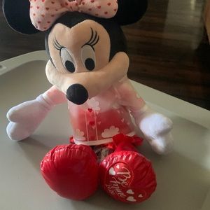 Minni mouse with pink bow tie on head red boots and a rain coat